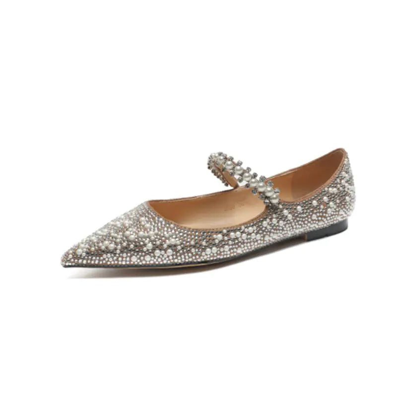 Pointed-toe flat shoe with crystal embellishments on a white background